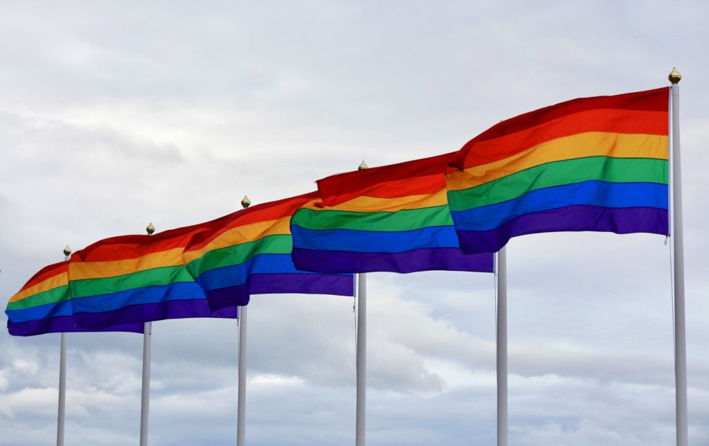 5 rainbow pride flags blowing in the wind