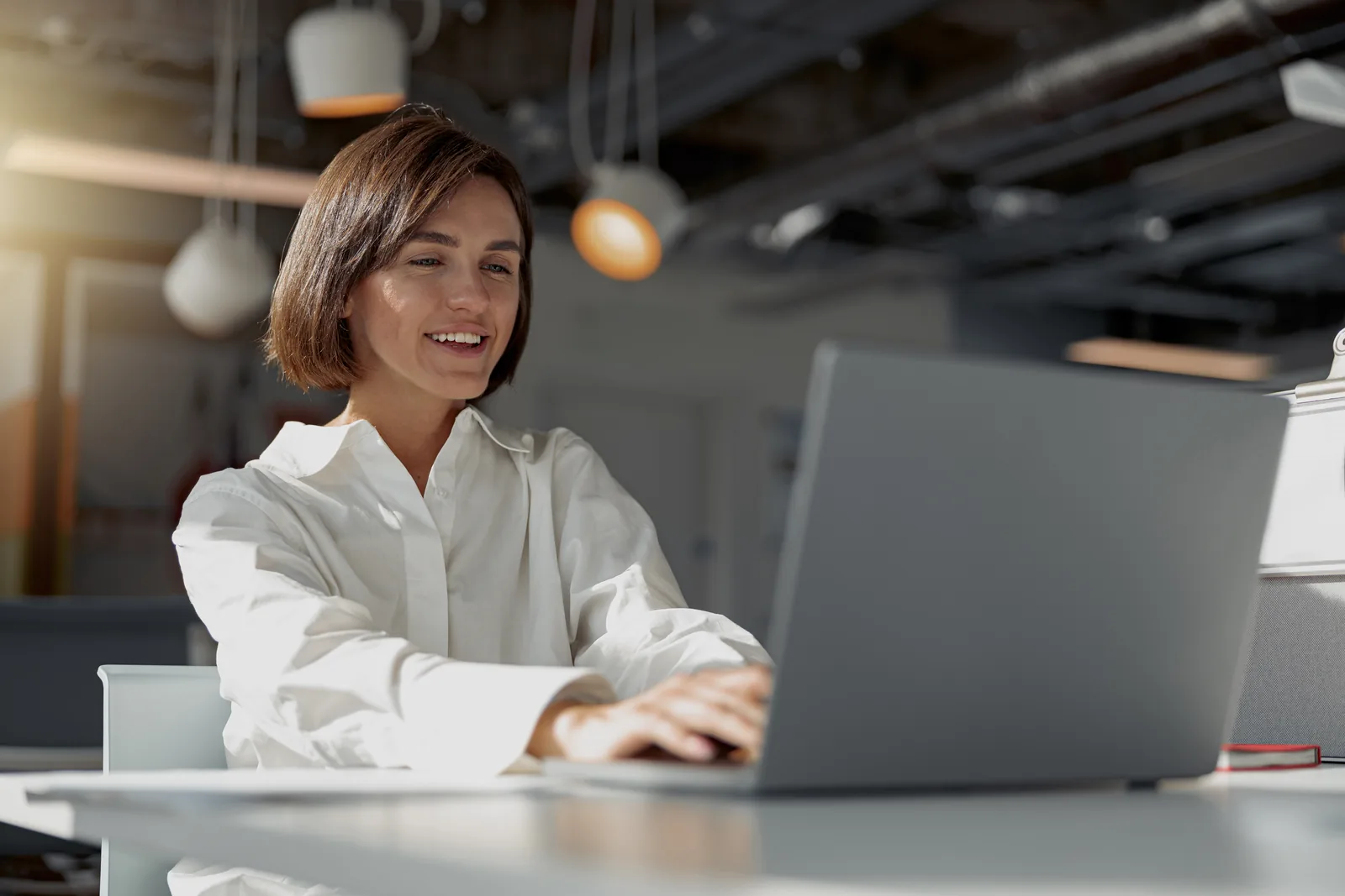 Smiling attorney reviewing SEO budget on laptop in modern office