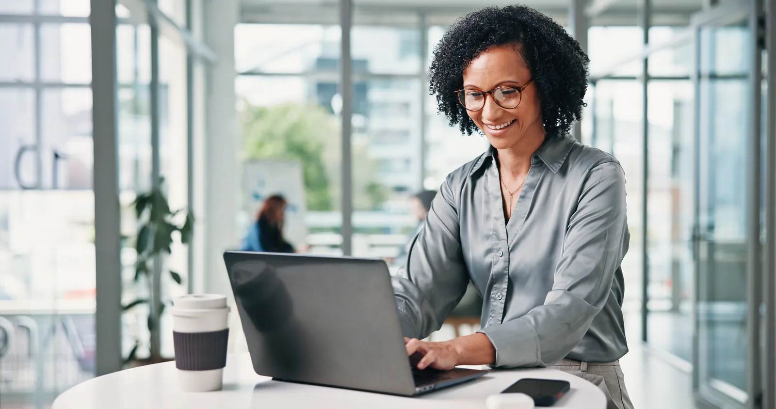 Solo attorney checking AI search visibility for her firm on a laptop in an open office