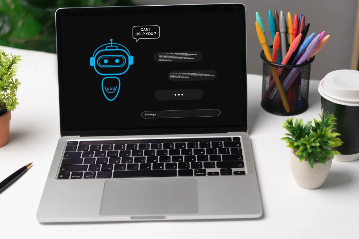 Laptop on a desk showing an AI chatbot screen