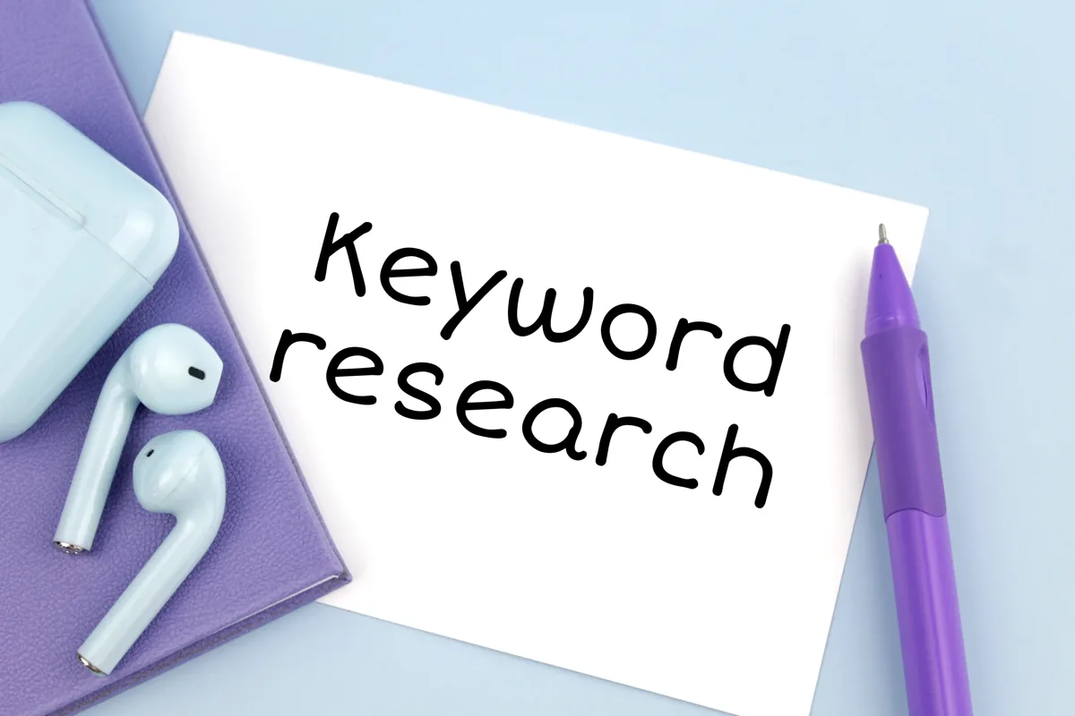 Keyword research written on a notecard with a purple pen
